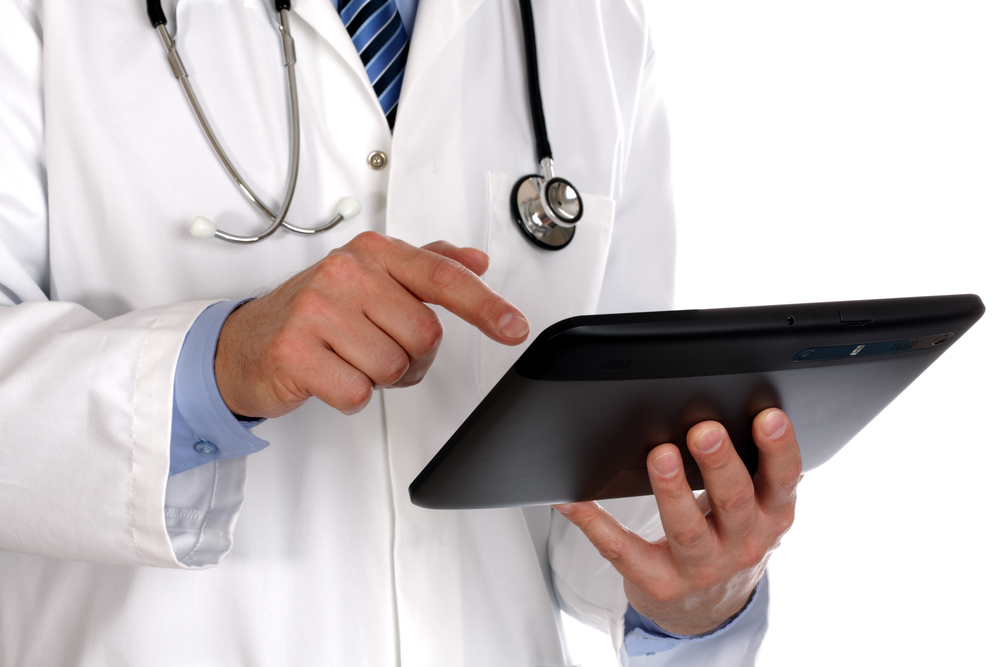 doctor with tablet device